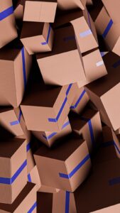 A large pile of brown cardboard boxes with blue tape.